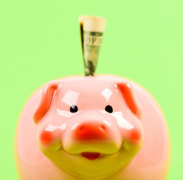 piggy bank with money sticking out of the top